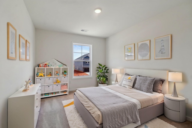 carpeted bedroom featuring visible vents