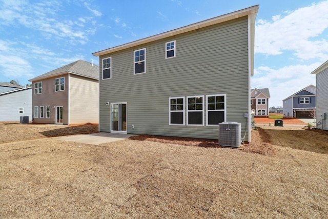 rear view of house with central air condition unit and a patio area