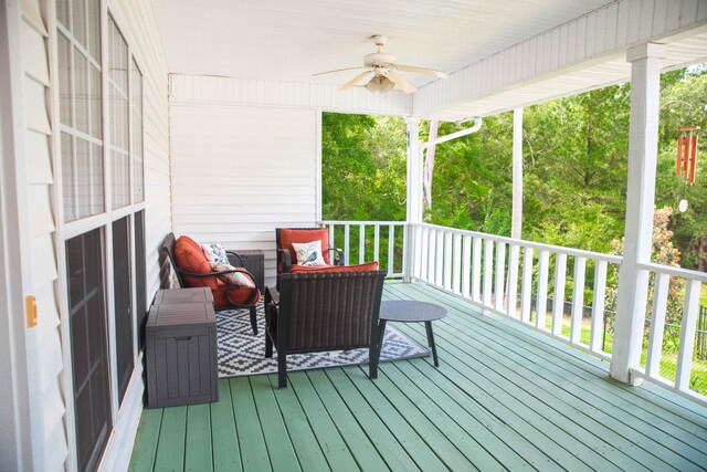 wooden terrace featuring ceiling fan