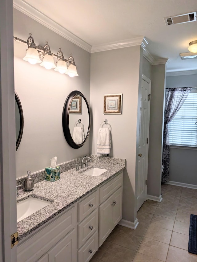 bathroom featuring tile patterned flooring, double vanity, ornamental molding, and baseboards