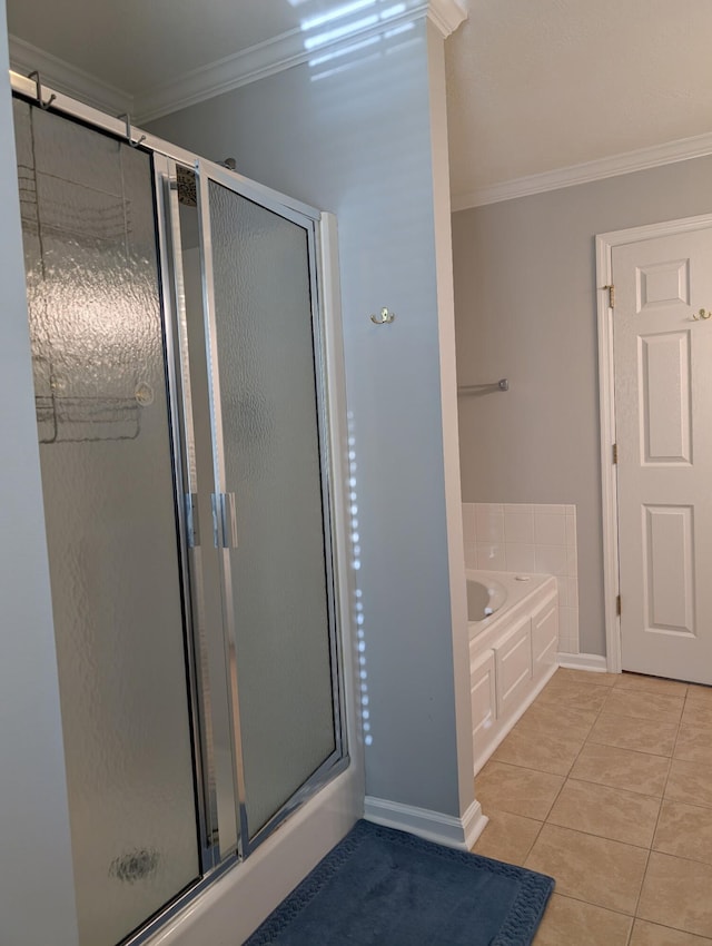 bathroom with crown molding, a stall shower, a garden tub, tile patterned flooring, and baseboards