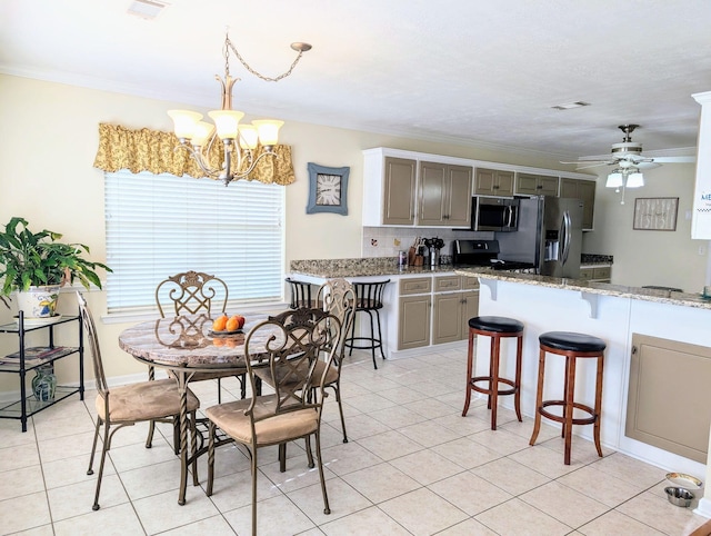 dining area with ornamental molding, a chandelier, light tile patterned floors, and a ceiling fan