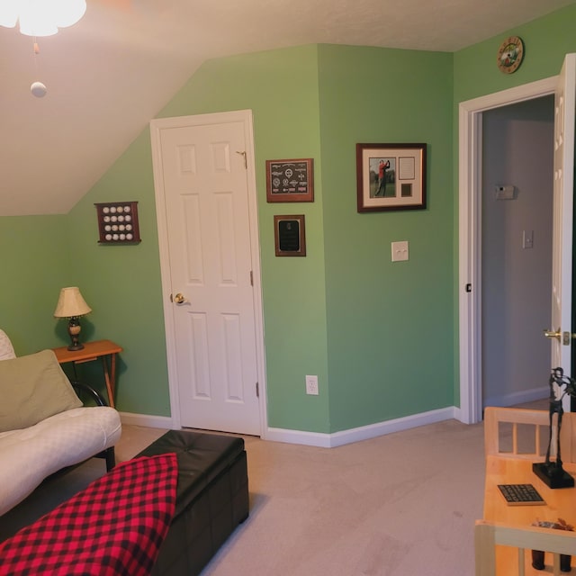 living room featuring light carpet, baseboards, and vaulted ceiling