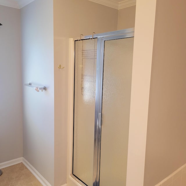 full bath featuring a shower stall, ornamental molding, tile patterned floors, and baseboards