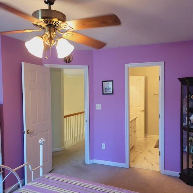 bedroom with baseboards, connected bathroom, ceiling fan, and light marble finish floors