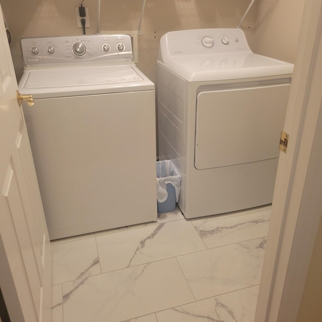 laundry room with separate washer and dryer and marble look tile flooring