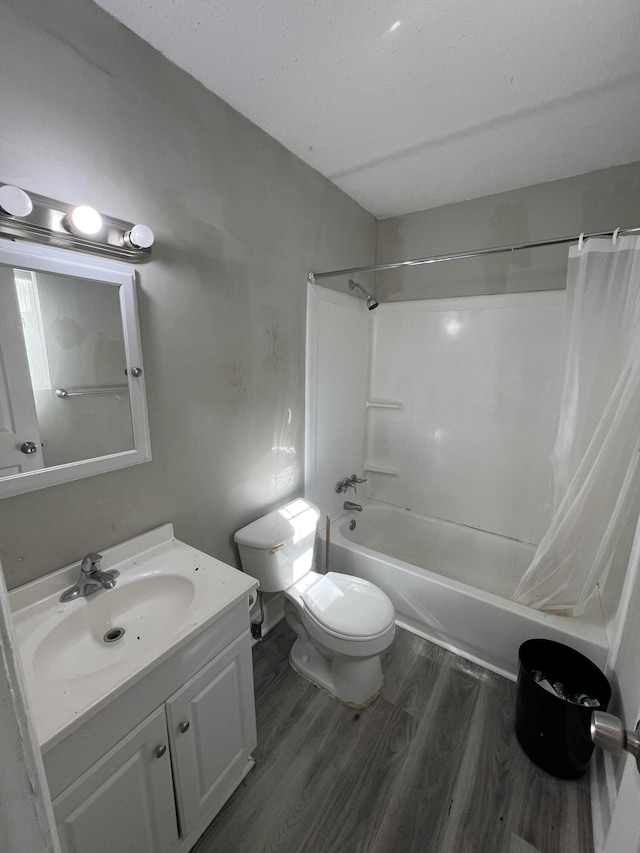 full bathroom featuring hardwood / wood-style floors, vanity, toilet, and shower / bath combo