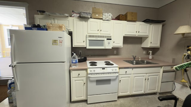 kitchen with white cabinets, white appliances, and sink