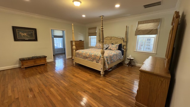 bedroom with ornamental molding, dark wood-type flooring, and multiple windows