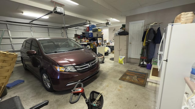 garage featuring a garage door opener and white refrigerator