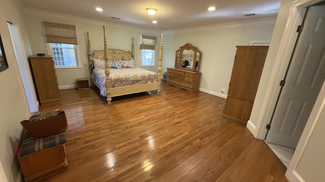 bedroom with hardwood / wood-style flooring and crown molding