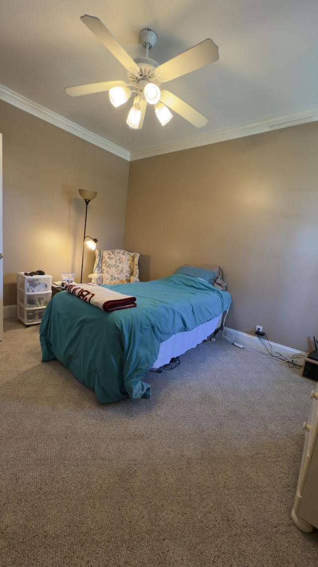 carpeted bedroom featuring ceiling fan and ornamental molding