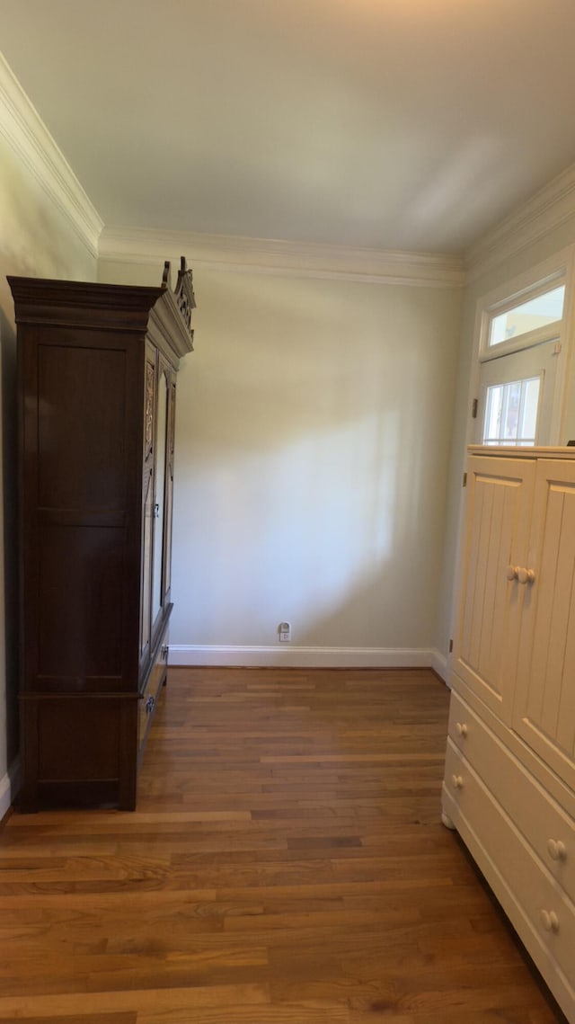 entryway featuring dark hardwood / wood-style floors and crown molding