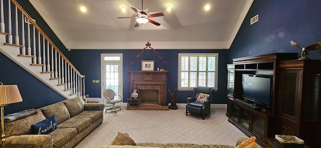 living room featuring carpet flooring, vaulted ceiling, and ceiling fan