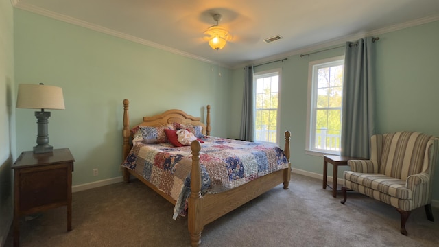 carpeted bedroom featuring ceiling fan and ornamental molding