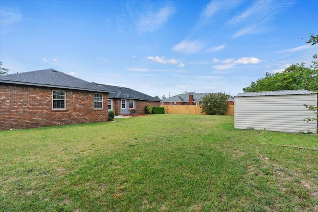 view of yard with an outbuilding and fence