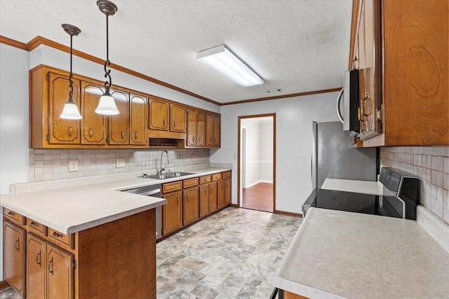 kitchen featuring a peninsula, a sink, brown cabinets, and tasteful backsplash