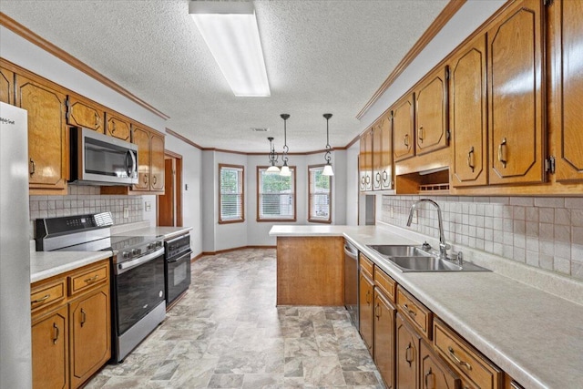 kitchen featuring a textured ceiling, crown molding, a sink, stainless steel appliances, and brown cabinetry