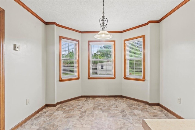 empty room with stone finish flooring, baseboards, ornamental molding, and a textured ceiling