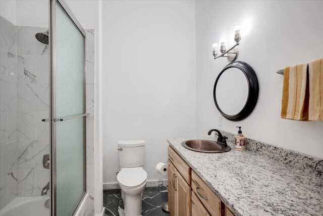 full bathroom featuring vanity, toilet, and enclosed tub / shower combo