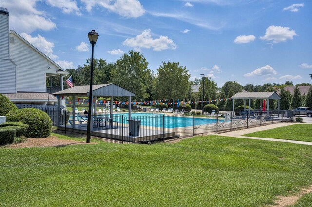 view of swimming pool with a gazebo and a yard