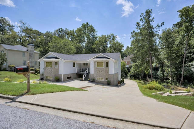 bi-level home with a front lawn