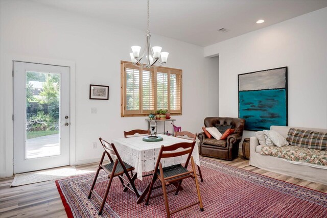 dining room featuring hardwood / wood-style flooring and a notable chandelier