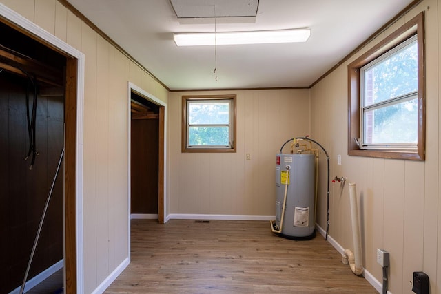 utility room featuring water heater and visible vents