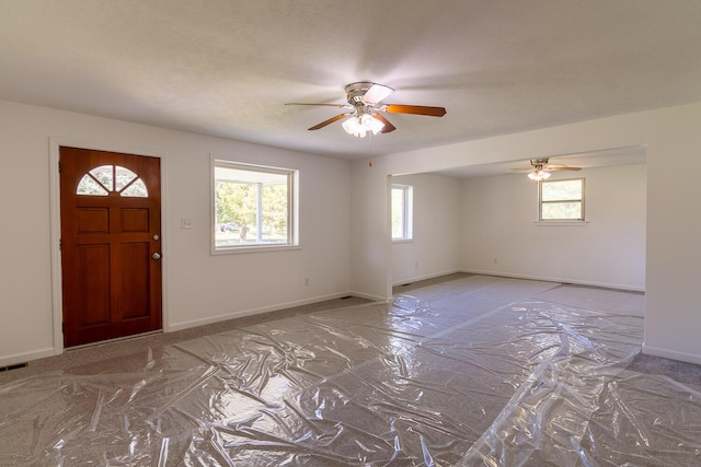 entryway with a ceiling fan and baseboards