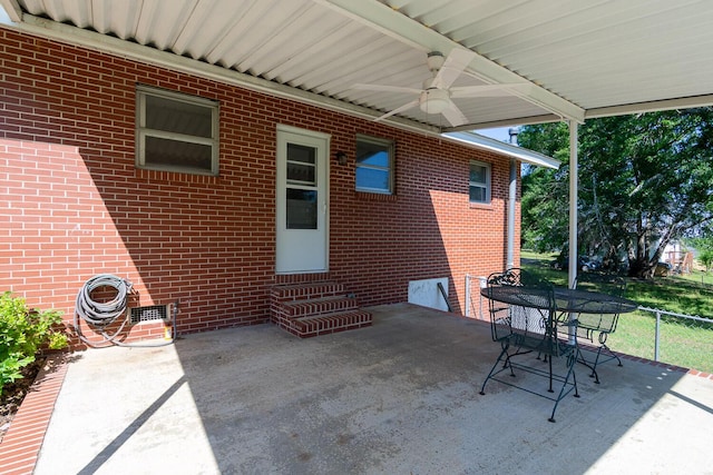 view of patio featuring a ceiling fan, outdoor dining space, entry steps, and fence