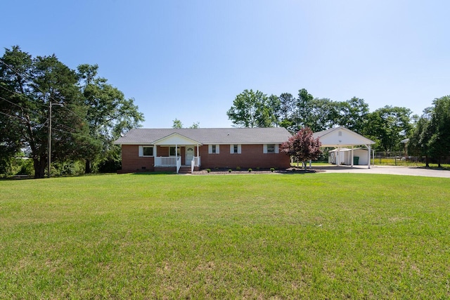 single story home featuring driveway, covered porch, a front lawn, and a carport