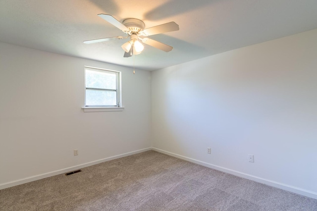 unfurnished room with visible vents, a ceiling fan, carpet flooring, and baseboards