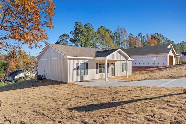 view of front of house featuring a front lawn and central air condition unit