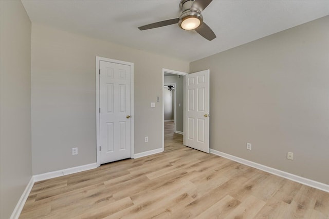 unfurnished bedroom featuring a ceiling fan, baseboards, and light wood finished floors