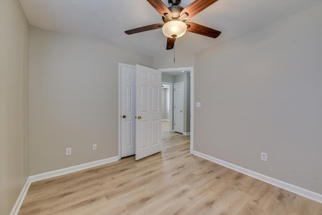 unfurnished bedroom featuring baseboards, light wood-type flooring, and ceiling fan