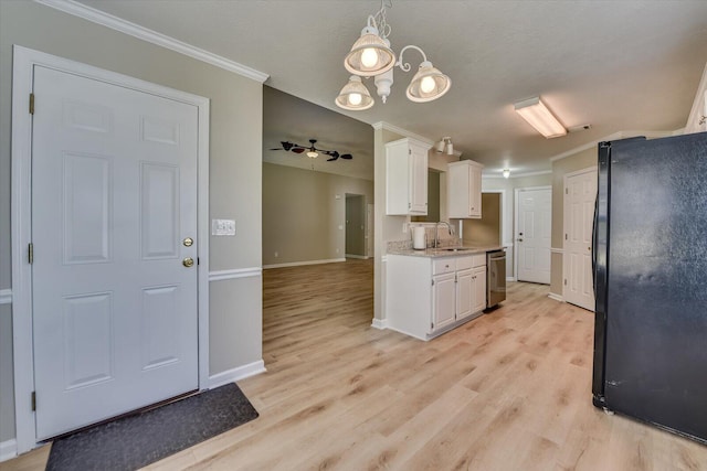 kitchen featuring dishwasher, white cabinets, crown molding, and freestanding refrigerator