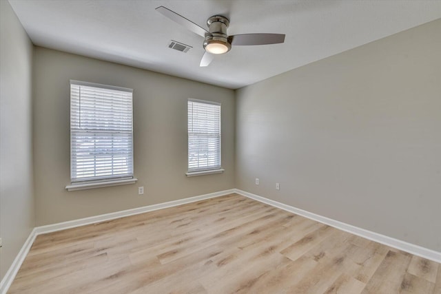 unfurnished room with baseboards, ceiling fan, and light wood finished floors