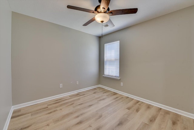 empty room with a ceiling fan, baseboards, and light wood finished floors