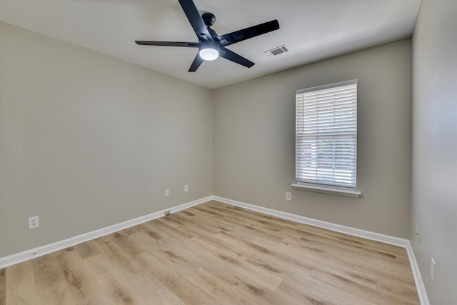 unfurnished room with visible vents, baseboards, light wood-style flooring, and a ceiling fan