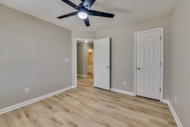 unfurnished bedroom featuring light wood-style flooring, a ceiling fan, and baseboards