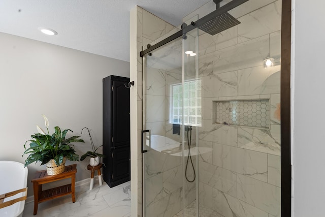 bathroom with a marble finish shower, marble look tiles, and baseboards