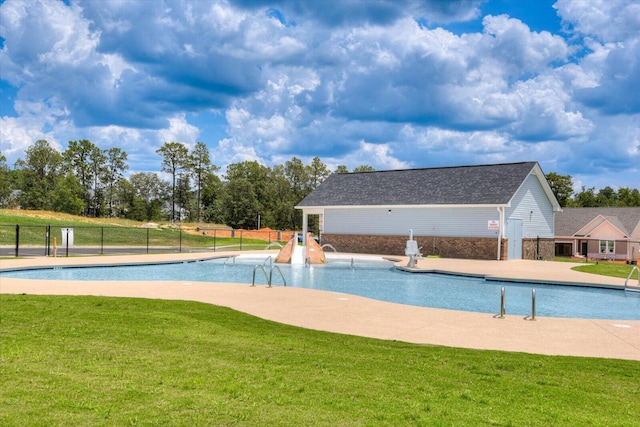 community pool with fence, a patio, and a yard