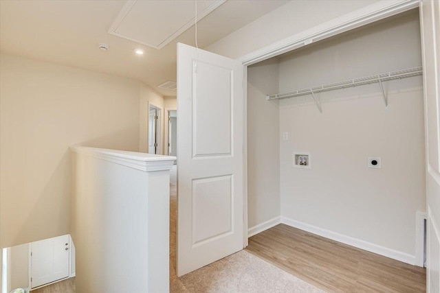 clothes washing area featuring hookup for a washing machine, light wood-style flooring, hookup for an electric dryer, laundry area, and attic access