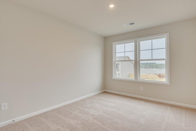 unfurnished room with recessed lighting, light colored carpet, and baseboards