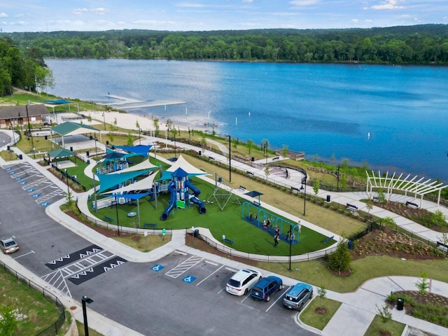 drone / aerial view featuring a water view and a wooded view