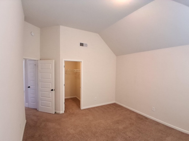 additional living space featuring lofted ceiling, baseboards, visible vents, and carpet