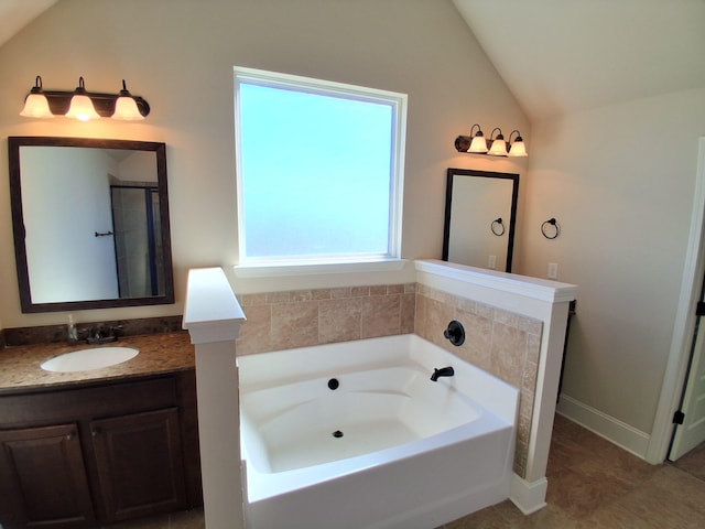 full bathroom with a garden tub, vaulted ceiling, and vanity