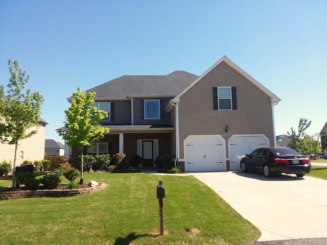 traditional-style home featuring a garage, concrete driveway, and a front yard