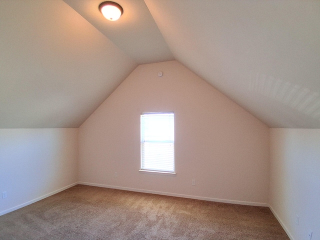 bonus room featuring carpet, baseboards, and vaulted ceiling