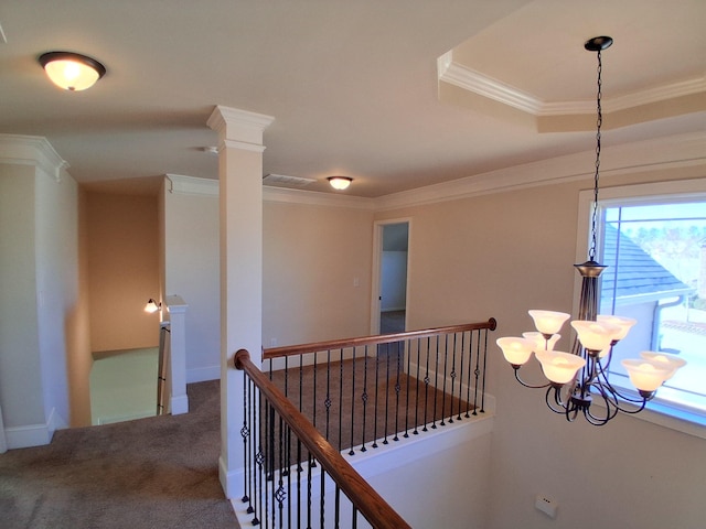 hall with carpet floors, crown molding, visible vents, an upstairs landing, and baseboards